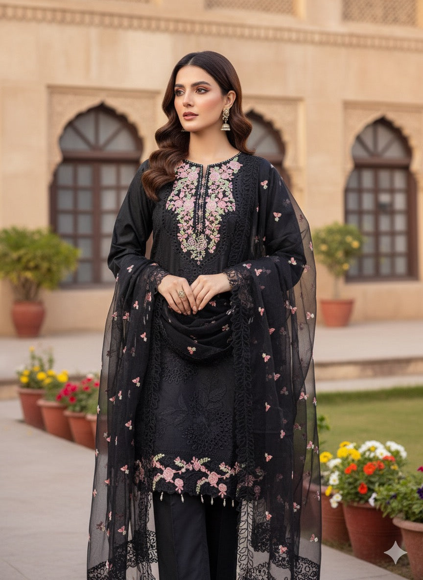 A sophisticated silk-blend suit featuring intricate tone-on-tone floral cutwork and contrasting bright thread embroidery on the neckline and dupatta.