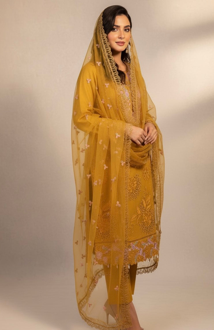 A sophisticated silk-blend suit featuring intricate tone-on-tone floral cutwork and contrasting bright thread embroidery on the neckline and dupatta.