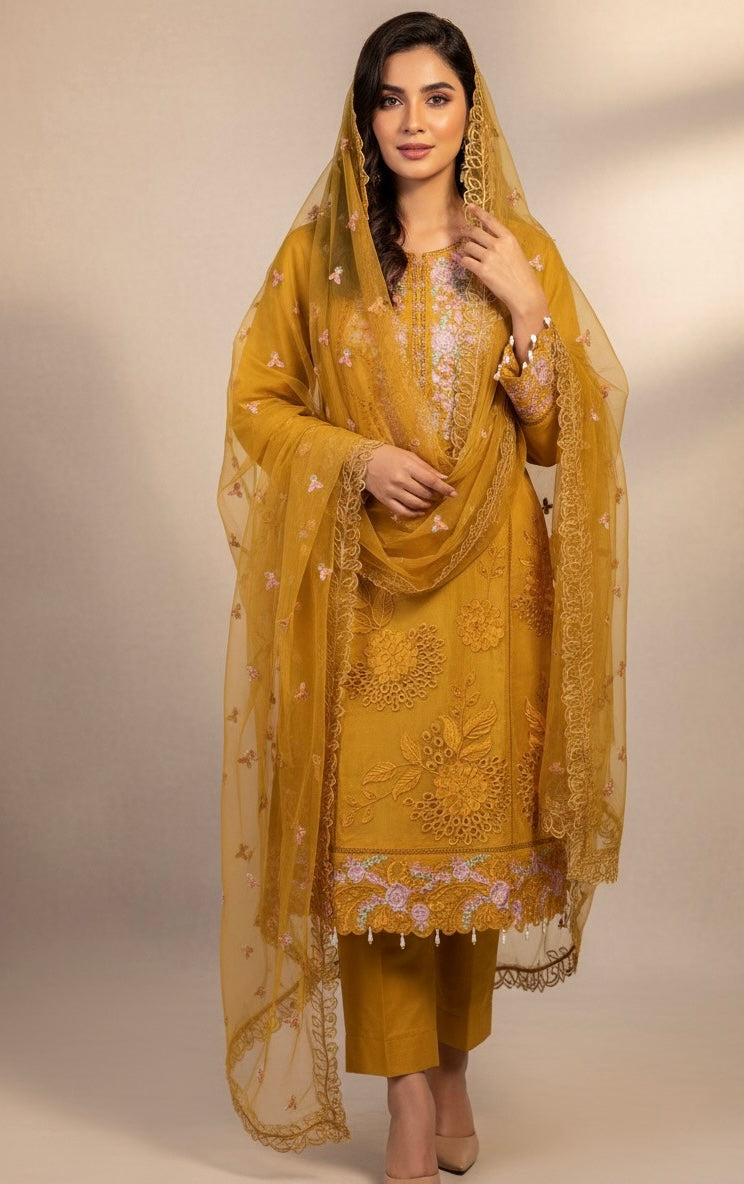 A sophisticated silk-blend suit featuring intricate tone-on-tone floral cutwork and contrasting bright thread embroidery on the neckline and dupatta.